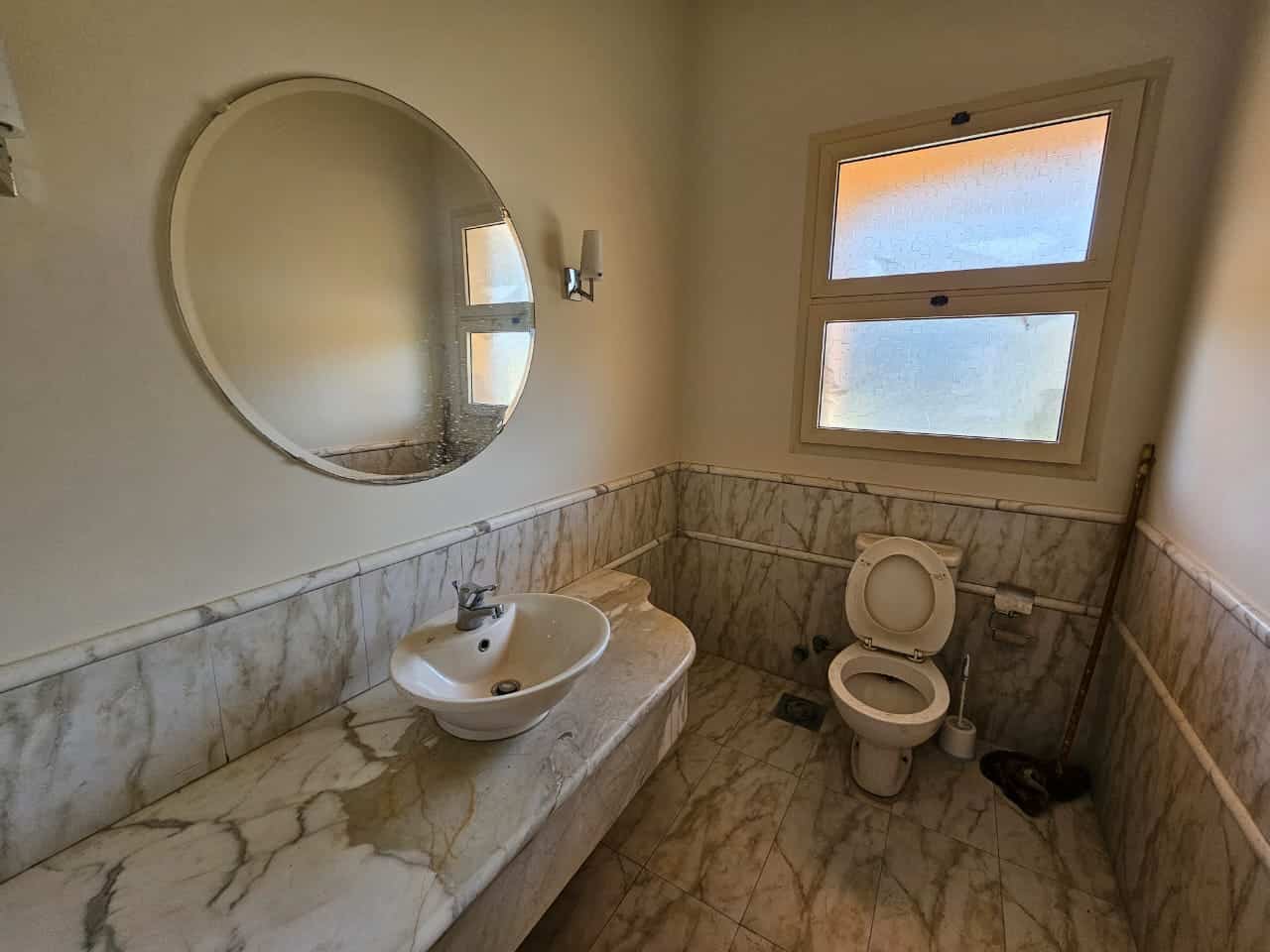 Bright bathroom with marble countertops and natural light in Maadi Cairo apartments for rent.