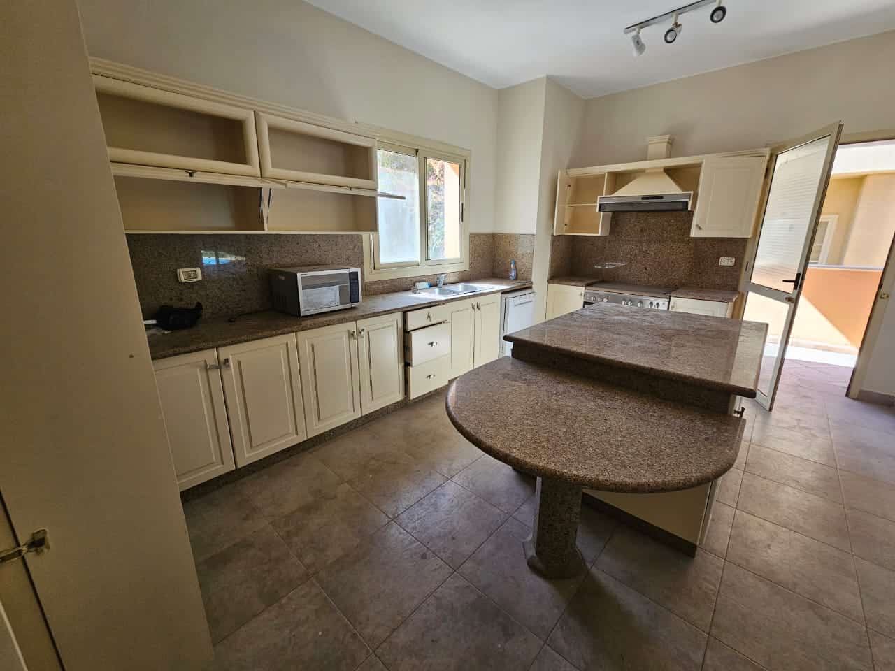 Spacious kitchen with ample cabinetry and modern appliances in Maadi Cairo apartment.