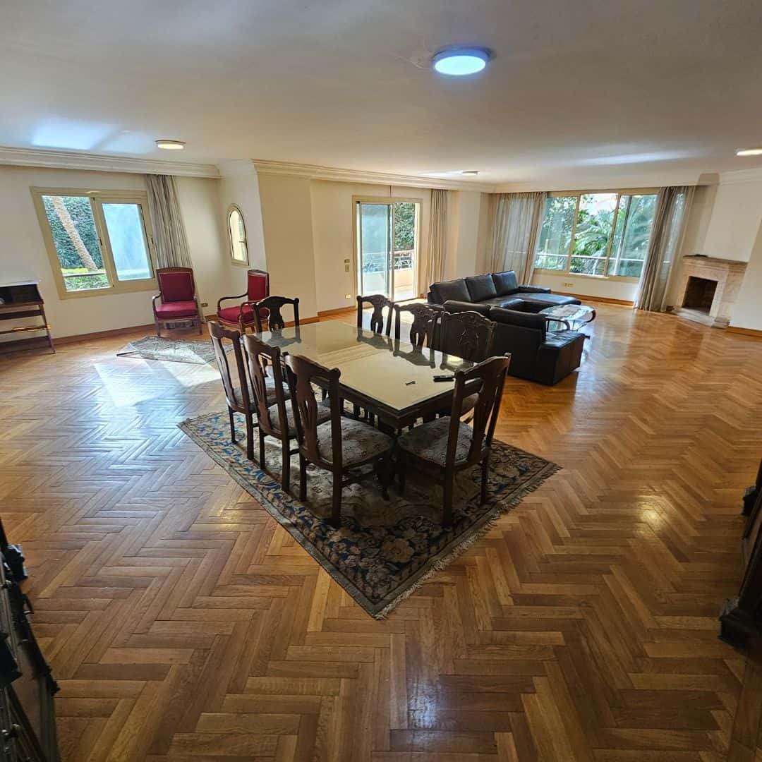 Spacious living room with large windows and elegant hardwood flooring in Maadi Cairo Egypt.