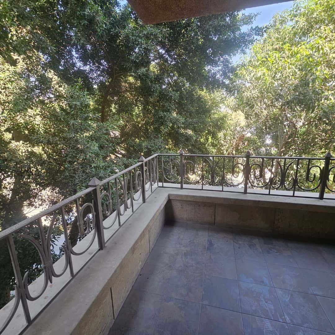 Balcony with lush green trees in Maadi Cairo Egypt, ideal for apartments and villas rental.