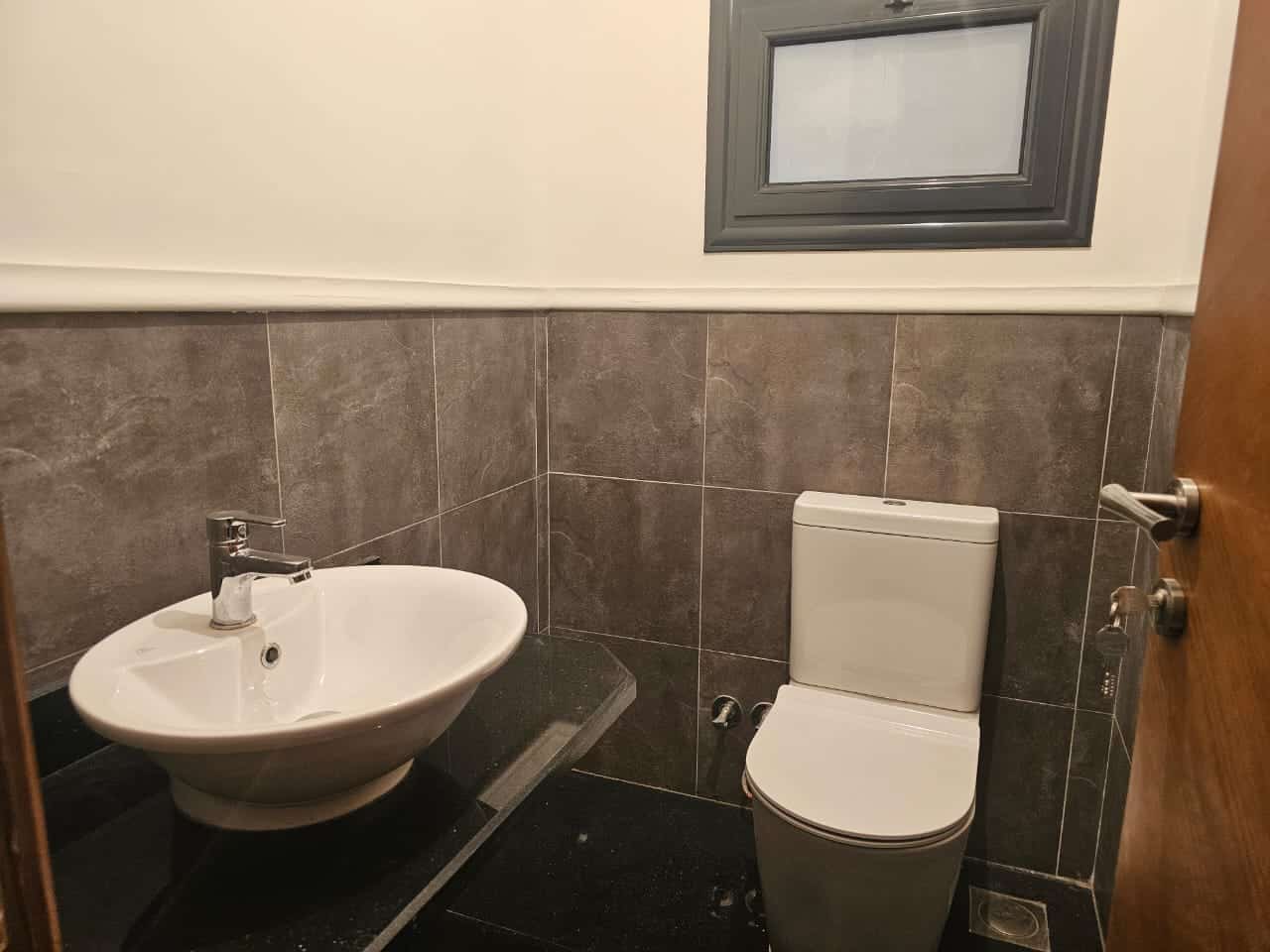Modern small bathroom with sink and toilet in Maadi Cairo Egypt.