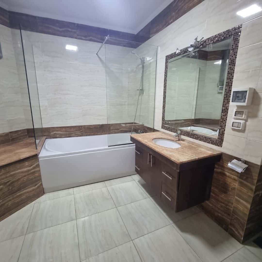 Spacious Duplex For Sale In Maadi Sarayat (6) Bright bathroom with bathtub, modern vanity, and elegant tile design in Maadi Cairo Egypt.