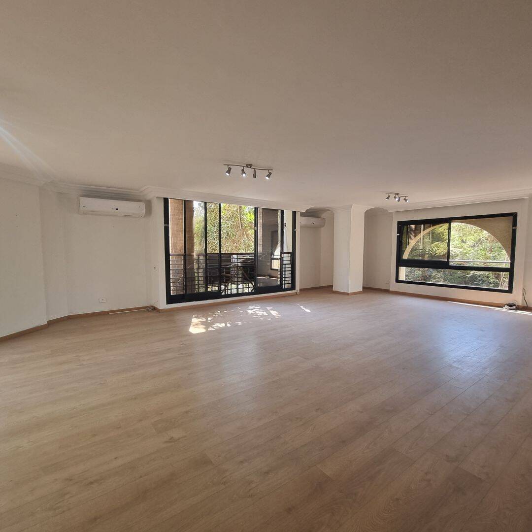 Spacious Duplex For Sale In Maadi Sarayat (9) Spacious modern apartment interior with large windows and wooden flooring in Maadi Cairo Egypt.