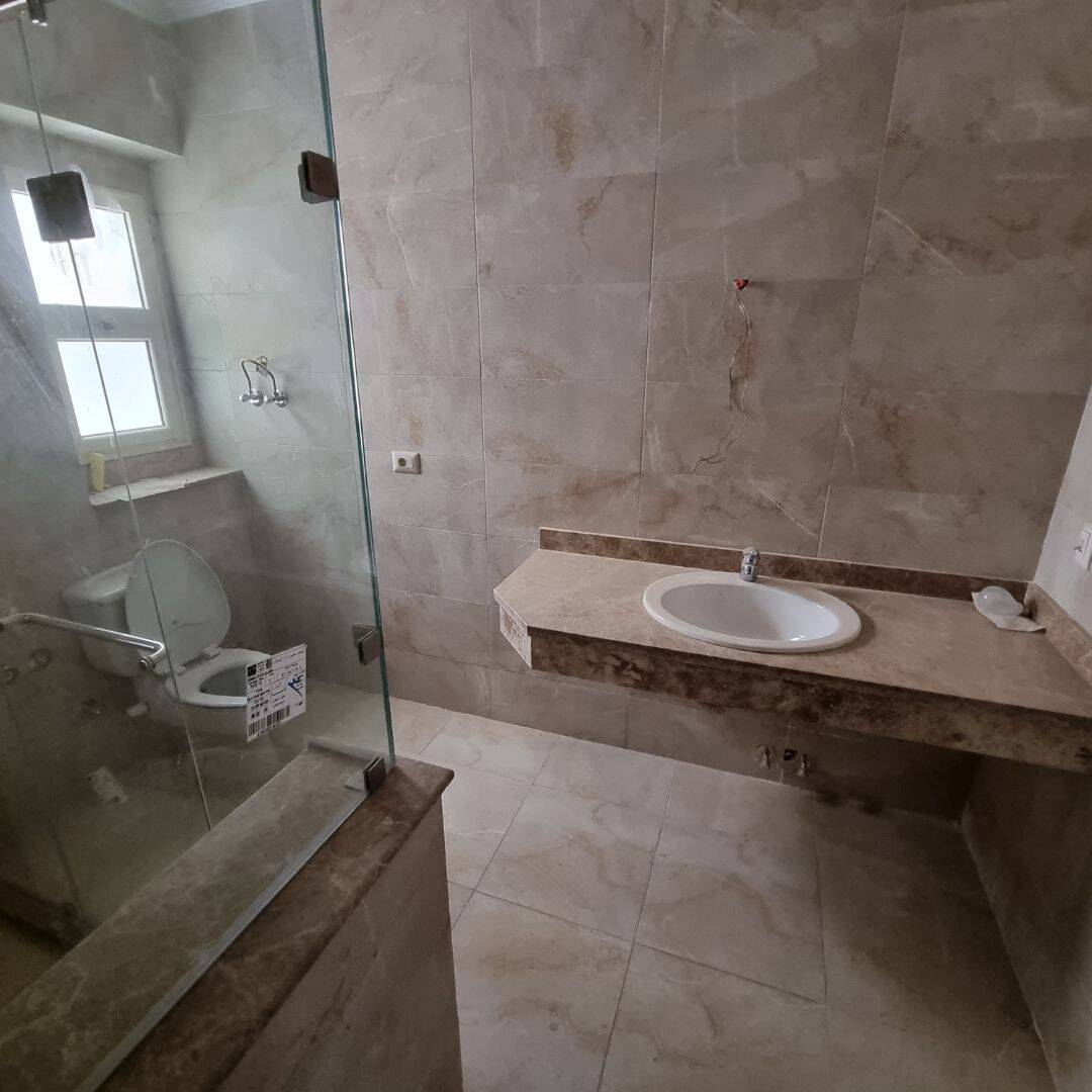 Modern bathroom with beige marble finishes and walk-in shower in Maadi Cairo Egypt.