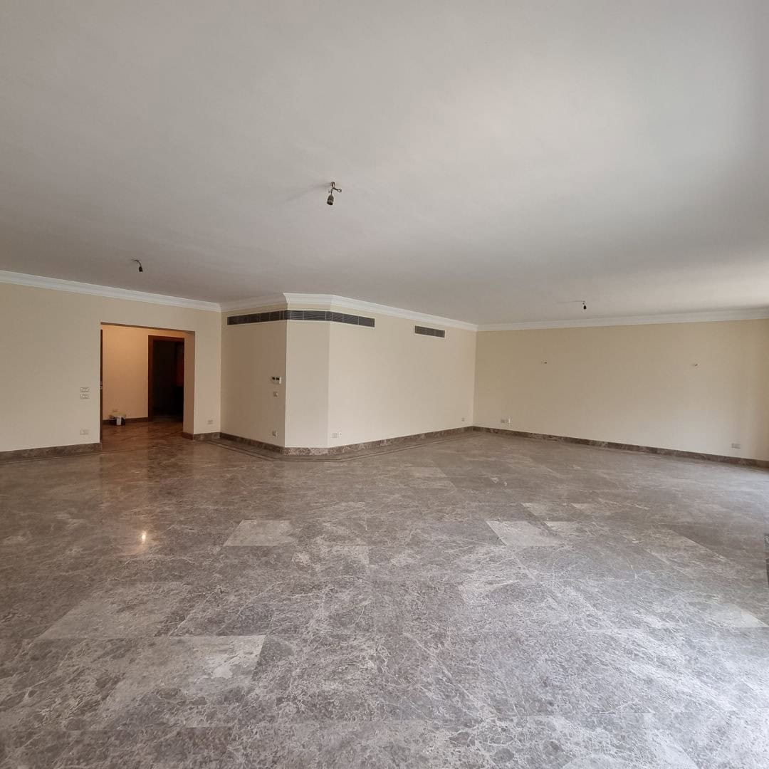 Spacious modern apartment interior with marble floors and neutral walls in Maadi, Cairo.